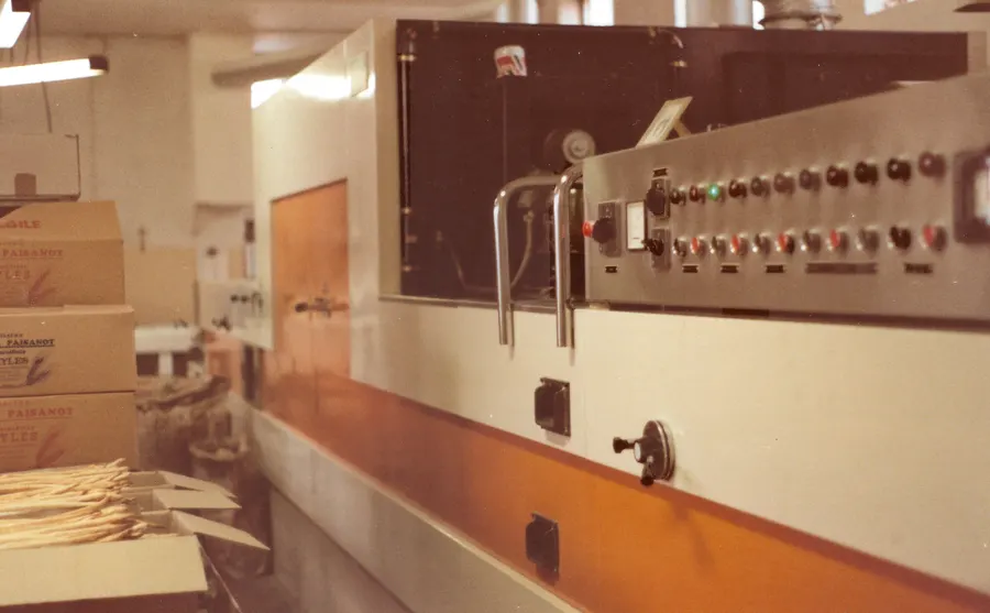 Foto d'epoca: il forno del laboratorio con il quadro dei comandi, e i grissini appena usciti nelle cassette